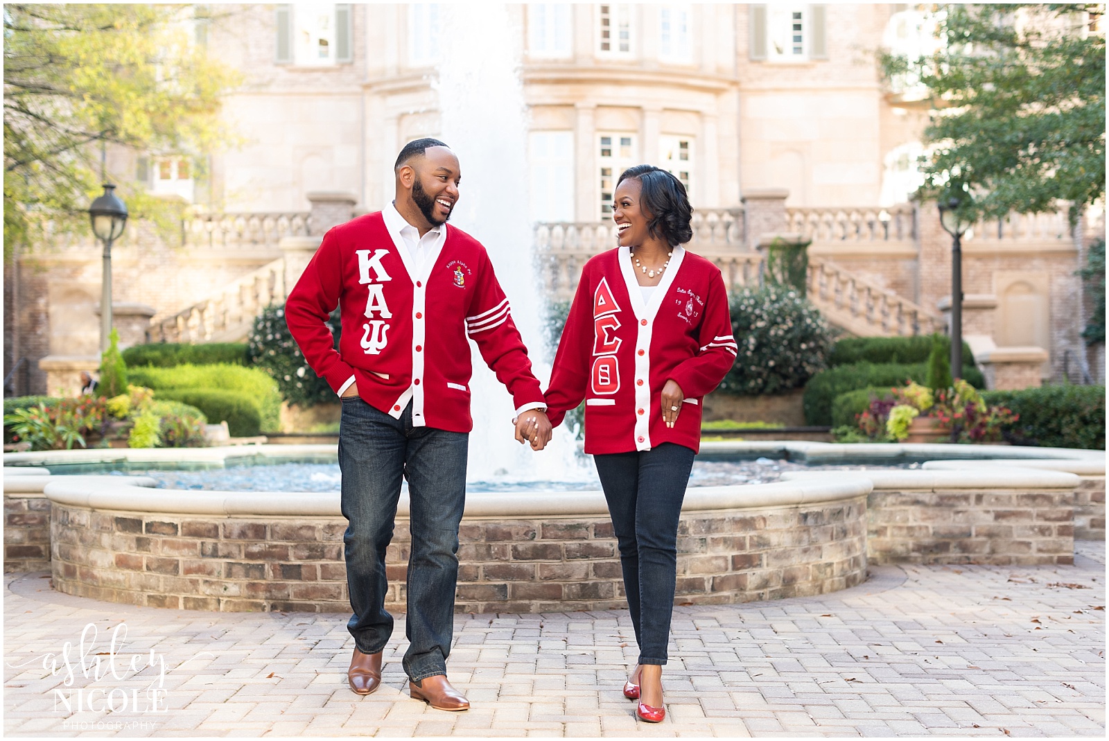 Couple smiling in front of fountain during Engagement Photos in Atlanta