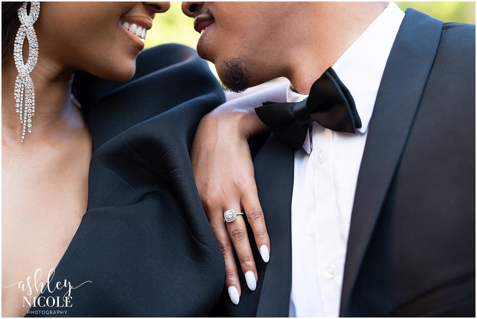 black couple smiling showing engagement ring