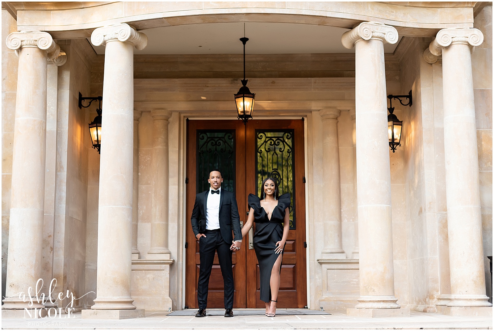 black couple holding hand in front of tall door