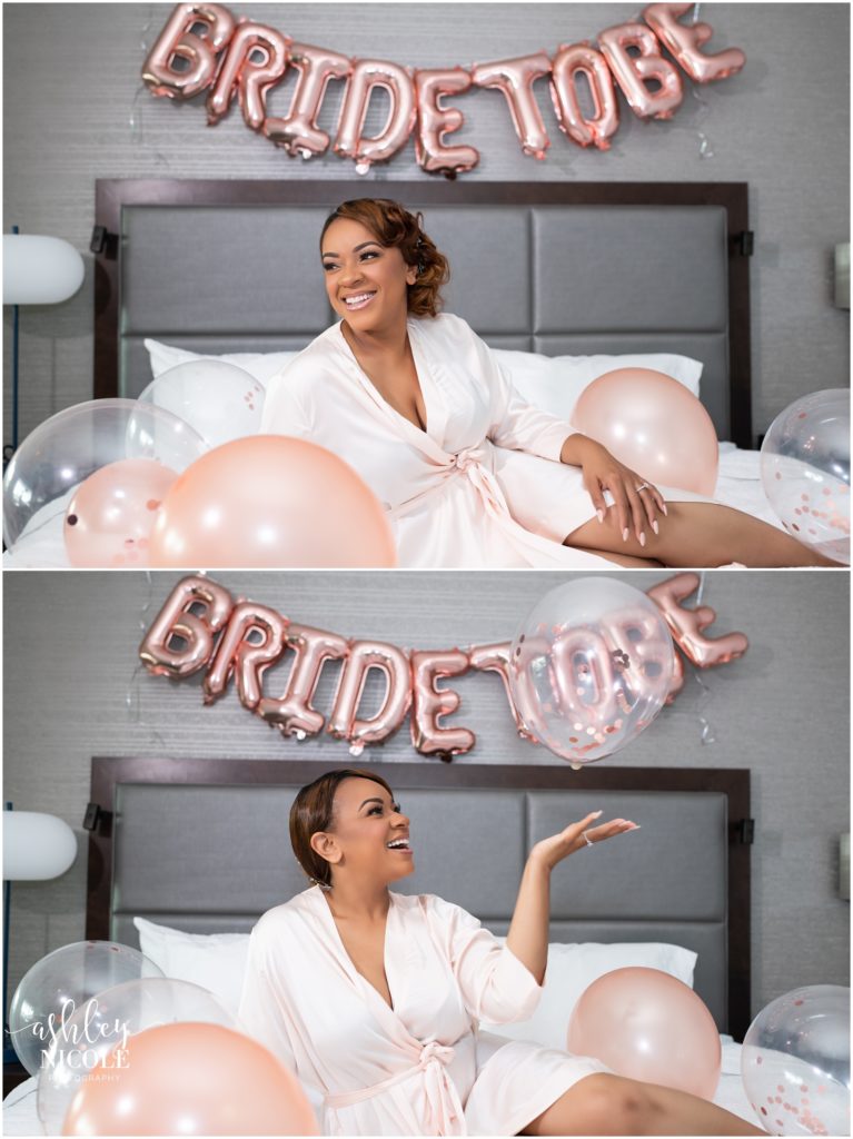 bride smiling laying on bed with balloons