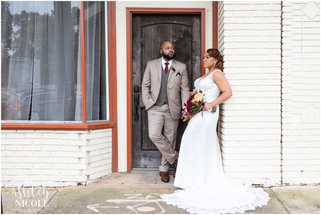 african american bride and groom standing by door