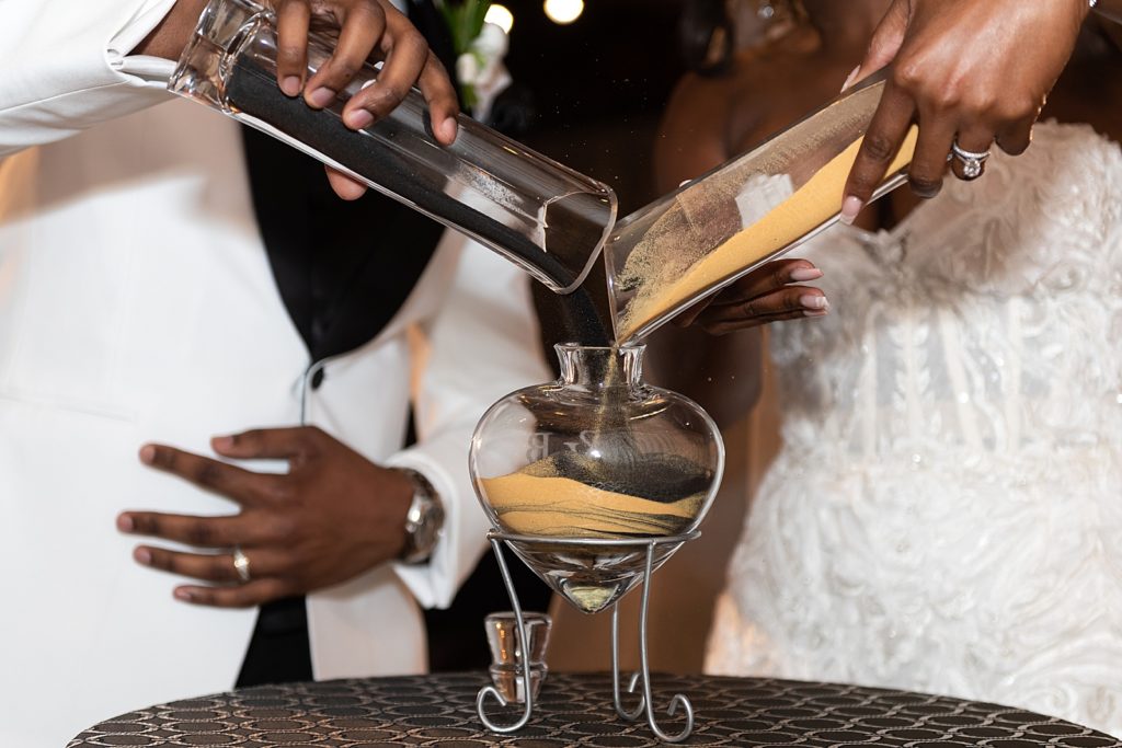 bride and groom pouring unity sand