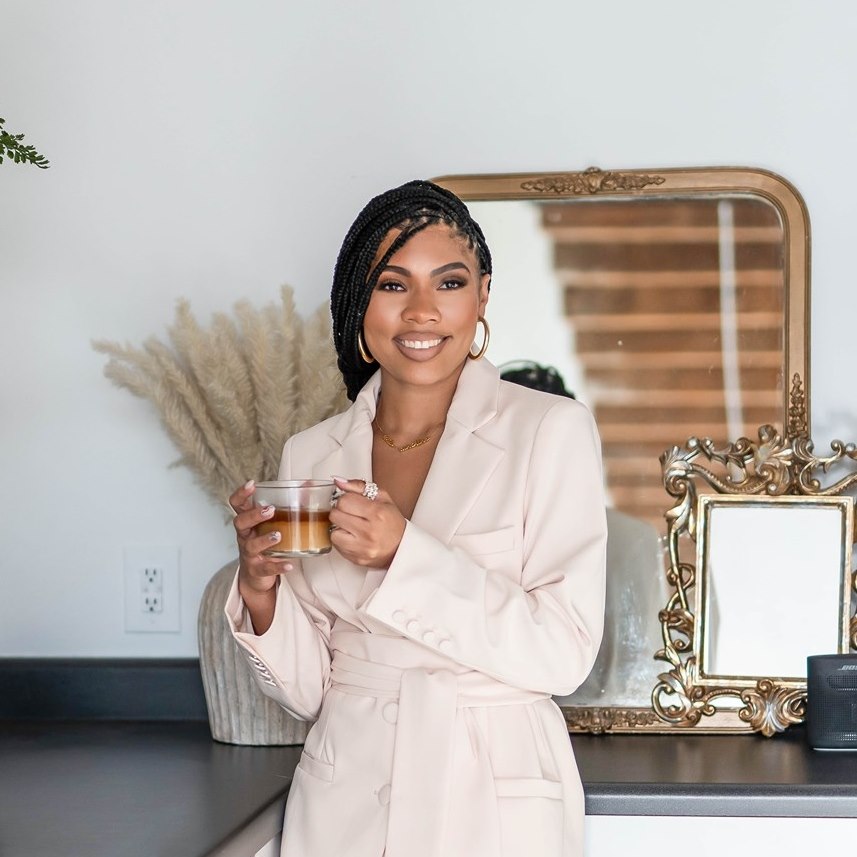 Black wedding planner holding coffee cup smiling | Maximize Your Photography Investment