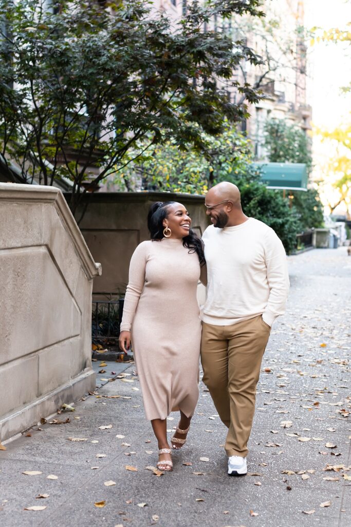 African american couple walking through Brooklyn brownstone neighborhood smiling
