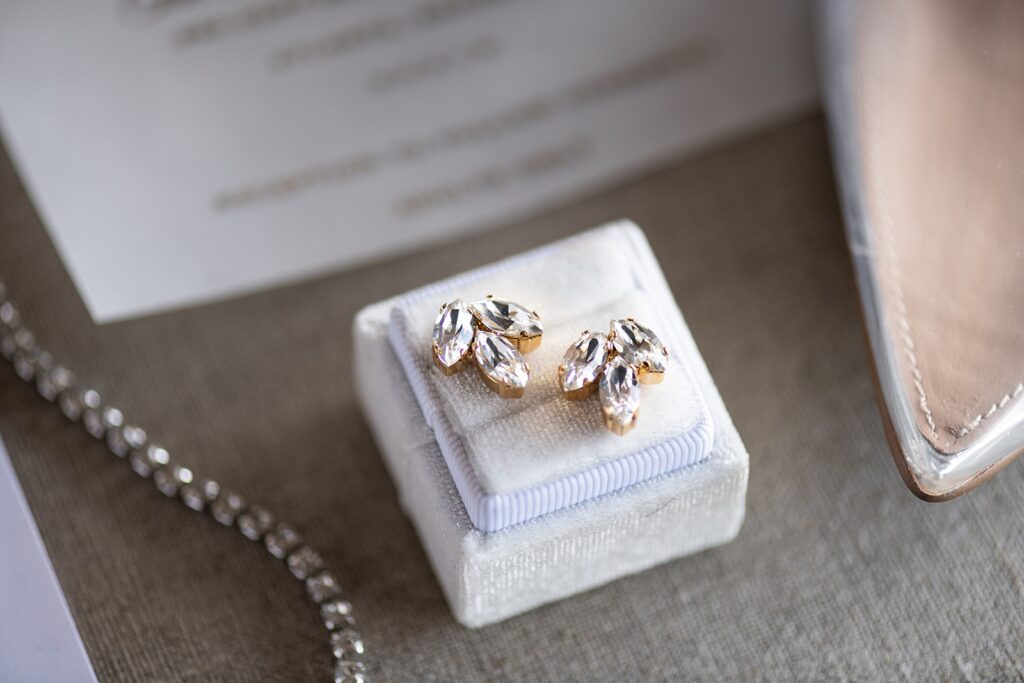 gold studded earrings in white ring box 