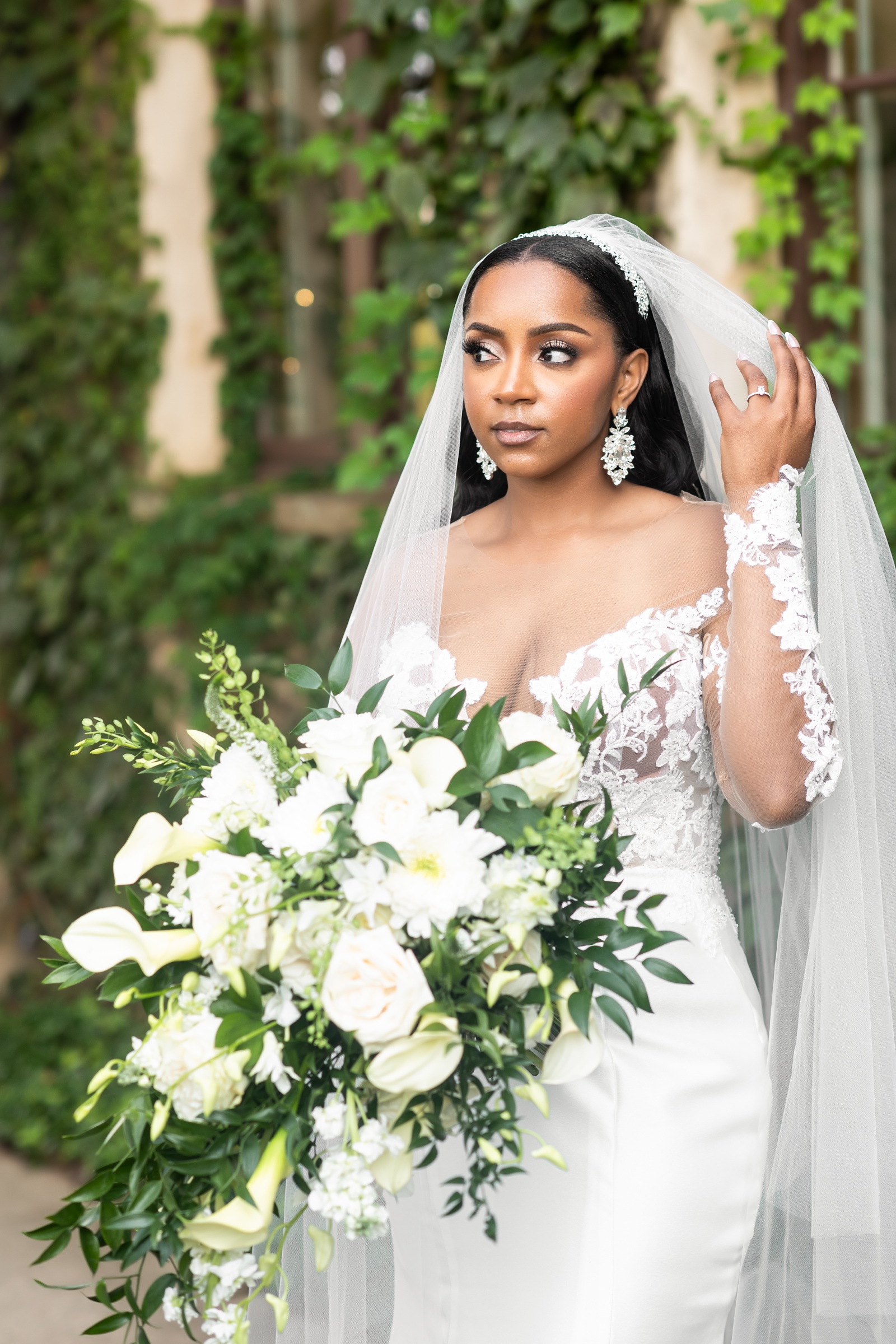 bride holding cascading white bouquet