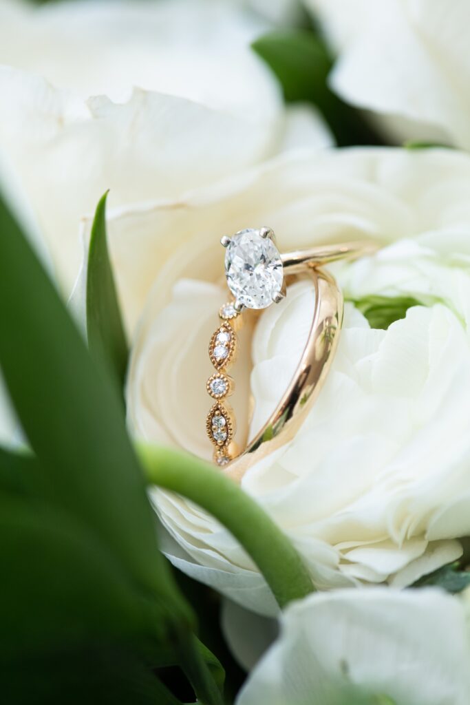 gold and diamond wedding rings in white flower
