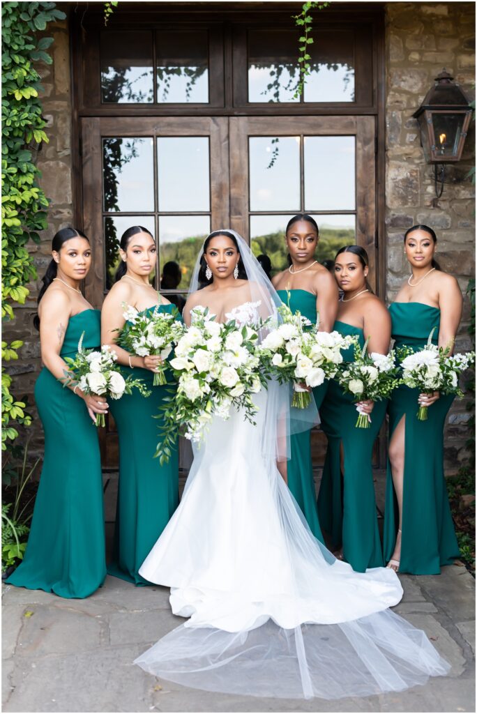 bride with her bridesmaids in emerald green dresses at montaluce winery wedding